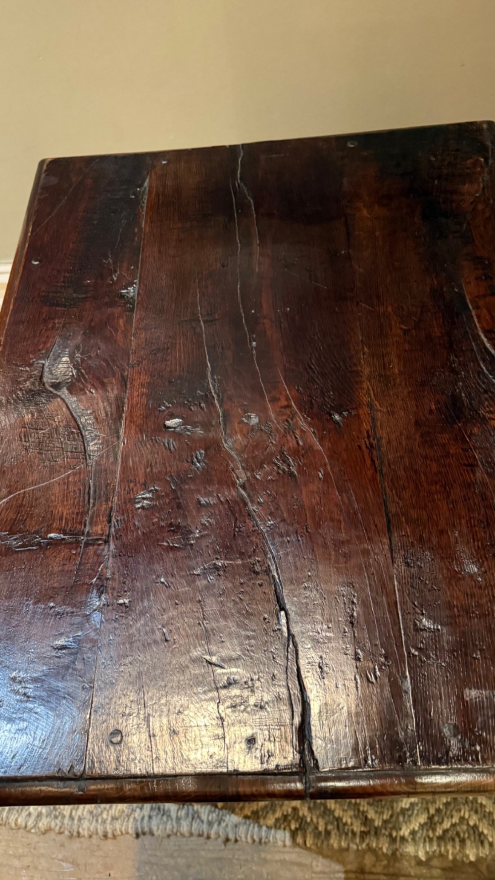 A dark oak 17th-century centre table featuring a carved fan-pattern apron, turned baluster legs, and sturdy wooden stretchers. View V
