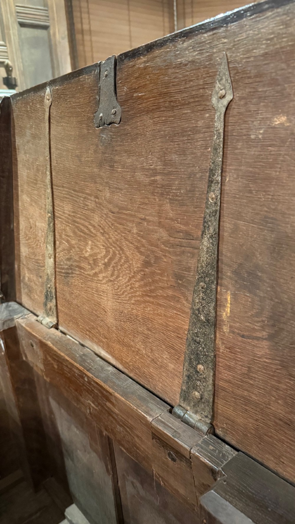 A 16th century carved oak coffer featuring double linenfold carved front panels and a large central iron lockplate. View X