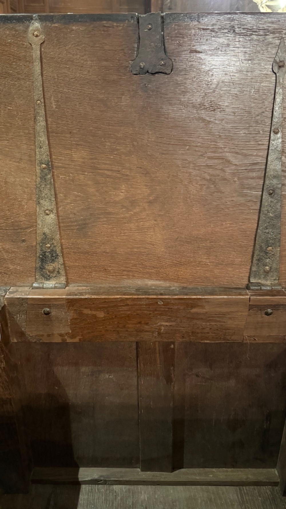 A 16th century carved oak coffer featuring double linenfold carved front panels and a large central iron lockplate. View XIII