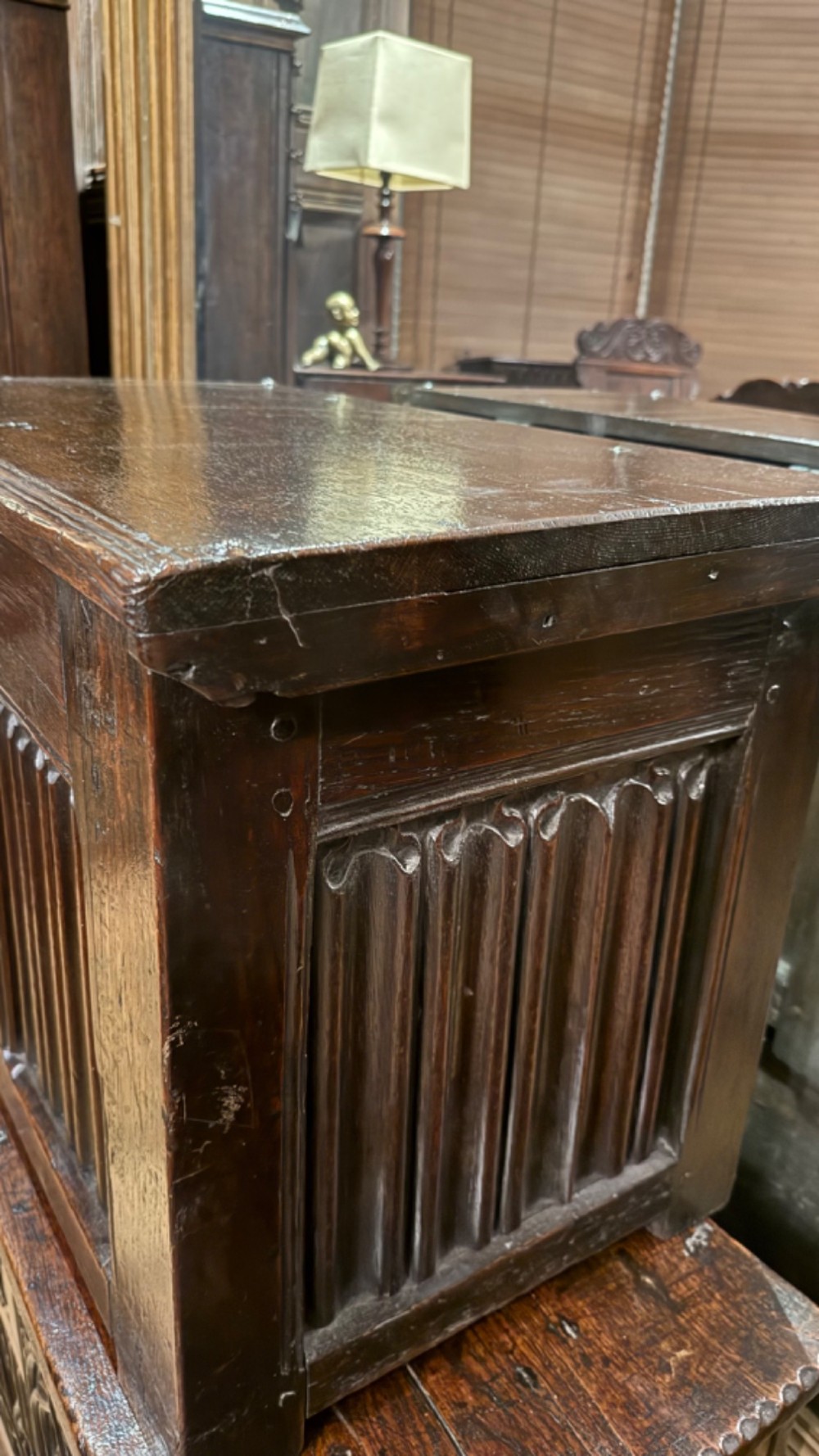 A 16th century carved oak coffer featuring double linenfold carved front panels and a large central iron lockplate. View XIV