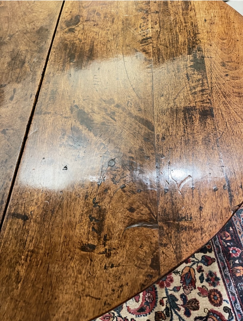 An 18th-century walnut gateleg table featuring an oval drop-leaf top supported by turned legs. View III