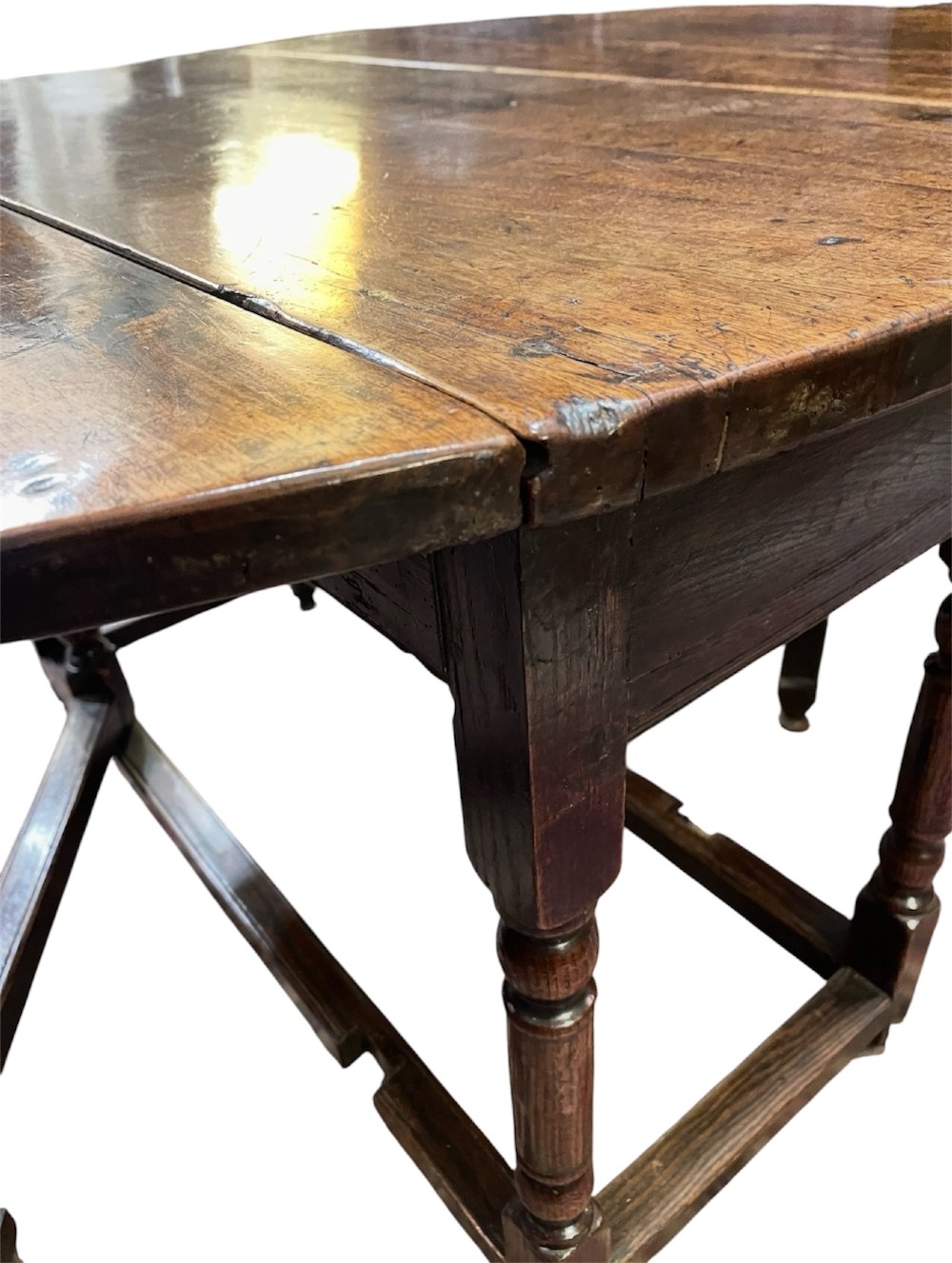 An 18th-century walnut gateleg table featuring an oval drop-leaf top supported by turned legs. View VIII