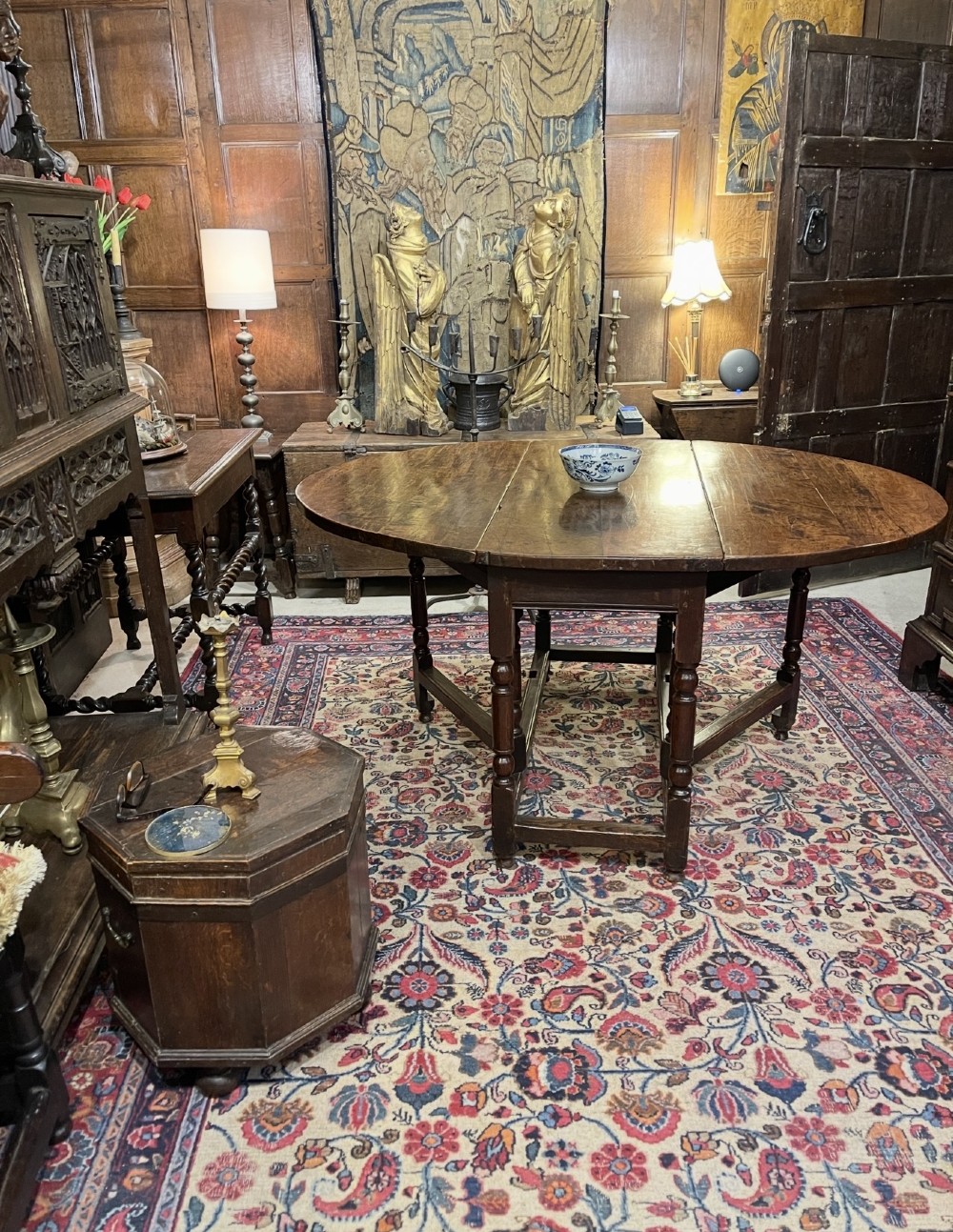 An 18th-century walnut gateleg table featuring an oval drop-leaf top supported by turned legs. View XIV