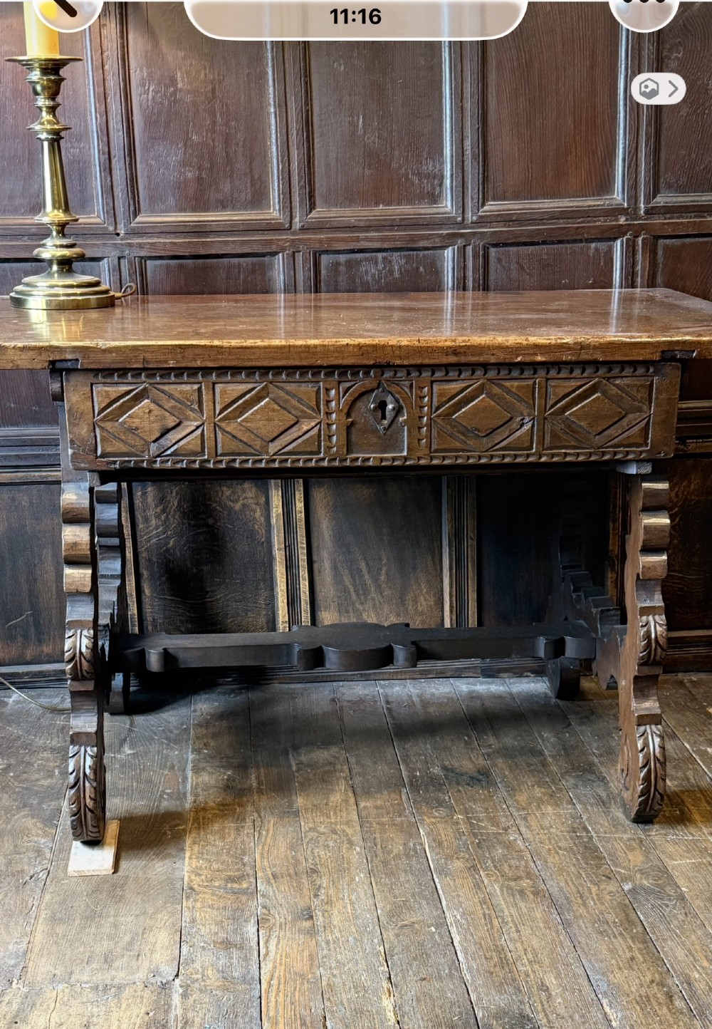A 17th-century dark walnut side table featuring a geometrically carved single drawer, detailed trestle end supports, and a shaped central stretcher. View III
