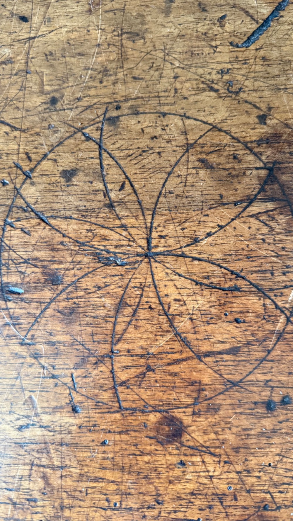A 17th-century dark walnut side table featuring a geometrically carved single drawer, detailed trestle end supports, and a shaped central stretcher. View X