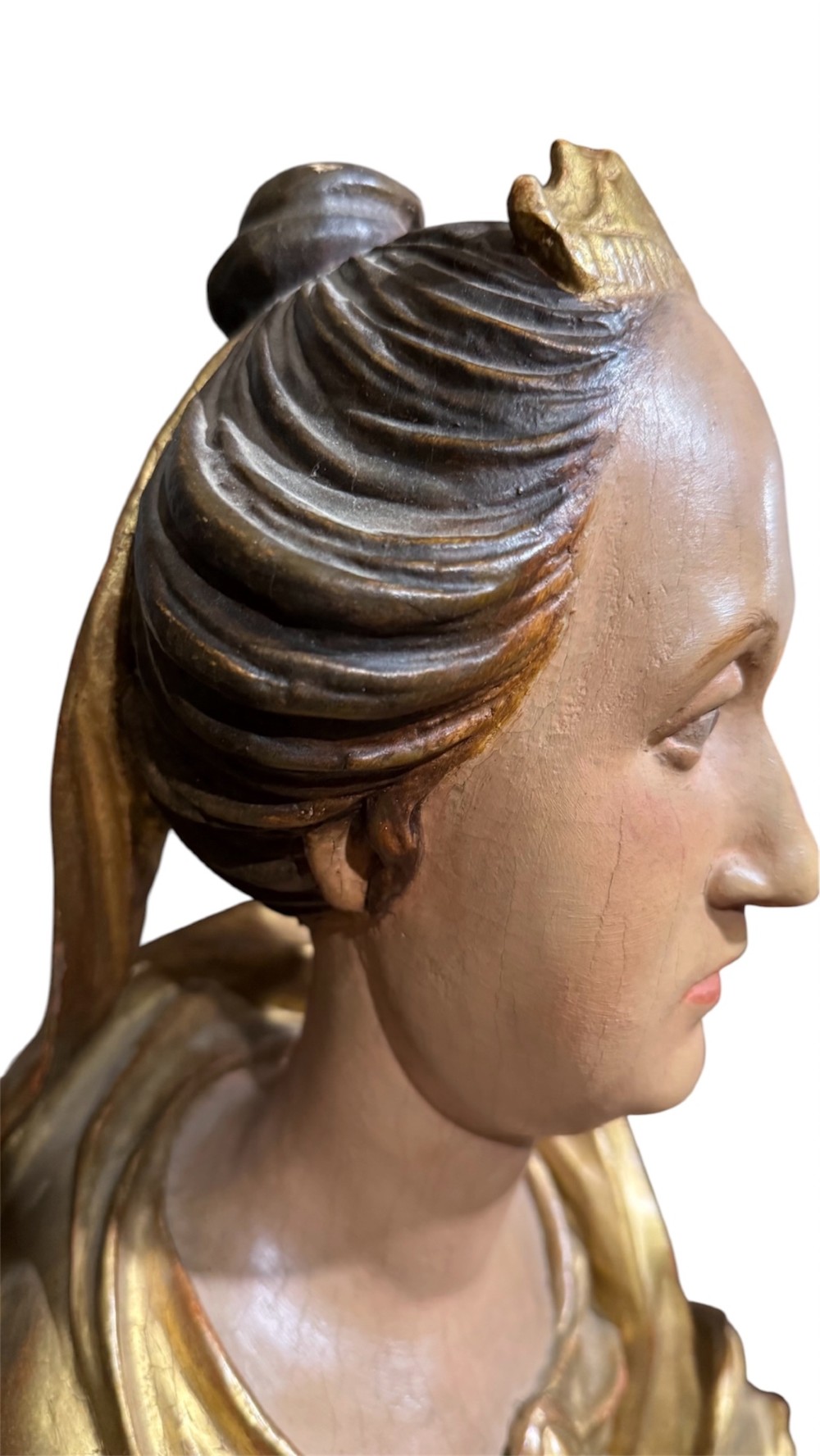 A seventeenth-century carved wooden bust of Saint Dorothea featuring gilded drapery and polychrome painted skin tones mounted on a decorative cartouche base. View V