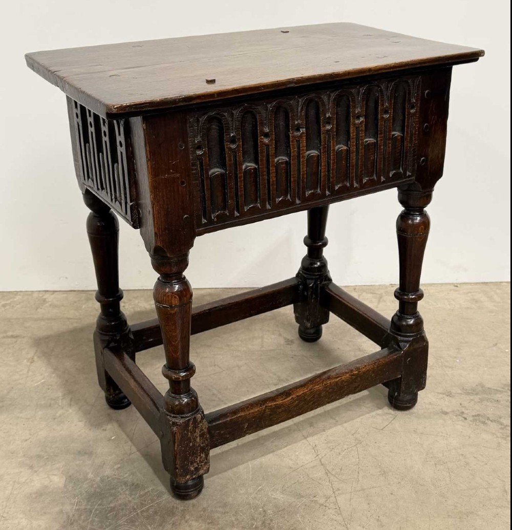 A 17th-century dark oak joint stool featuring a carved arcade frieze, turned legs, and sturdy base stretchers. View IV