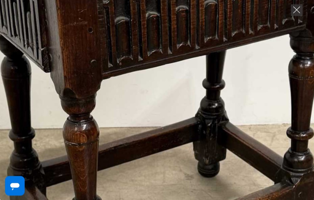 A 17th-century dark oak joint stool featuring a carved arcade frieze, turned legs, and sturdy base stretchers. View VI