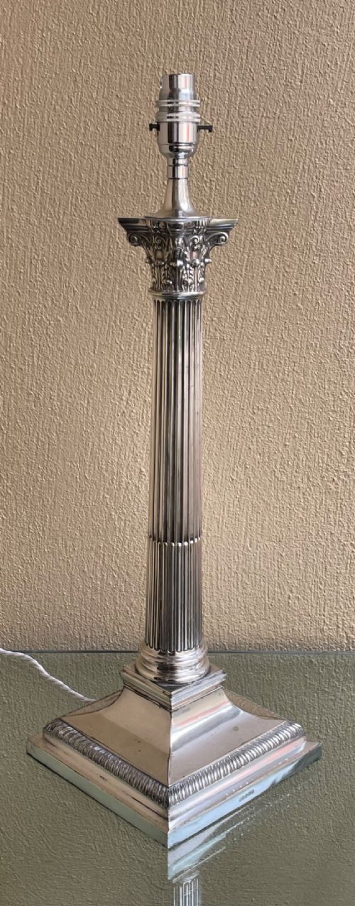 An Edwardian silver-plated table lamp shaped as a fluted Corinthian column on a stepped square base. View II