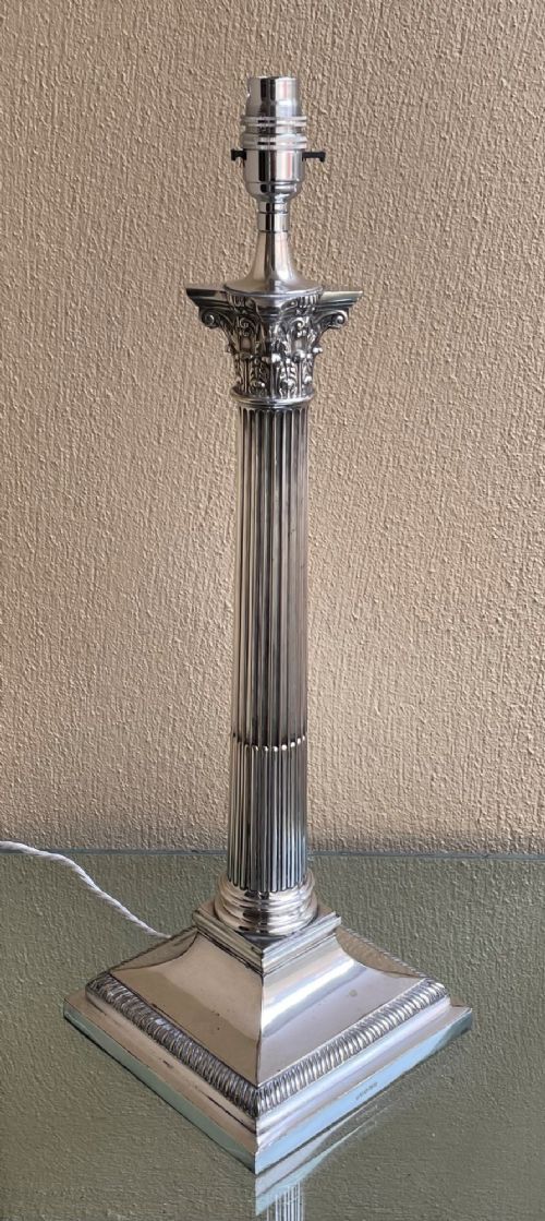 An Edwardian silver-plated table lamp shaped as a fluted Corinthian column on a stepped square base. View III