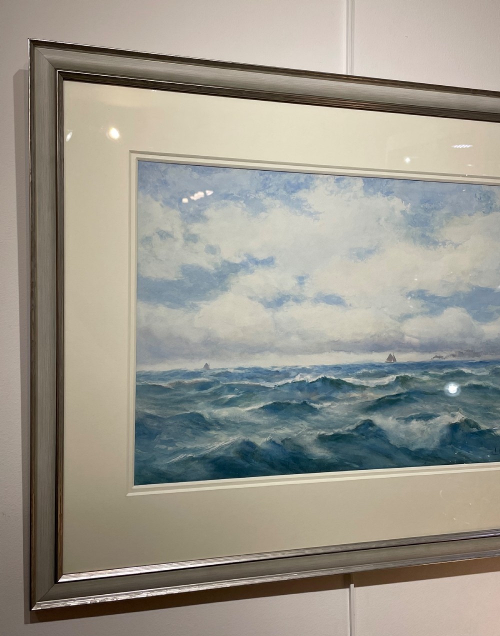 A framed watercolour painting depicting choppy blue ocean waves with distant sailing vessels under a cloudy sky. View IV