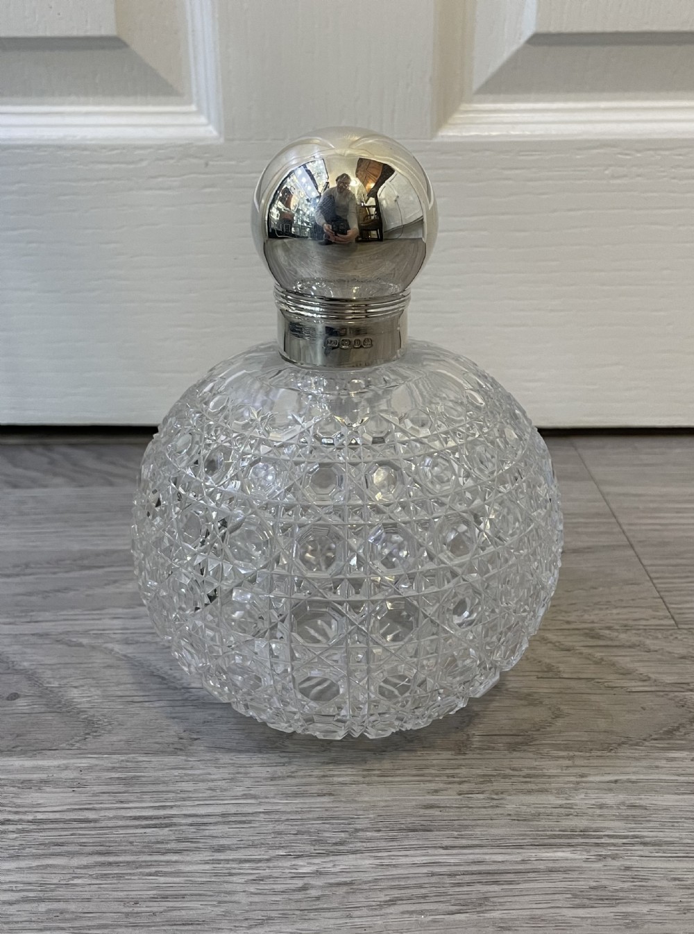 A very large Victorian solid silver topped globular cut glass scent bottle