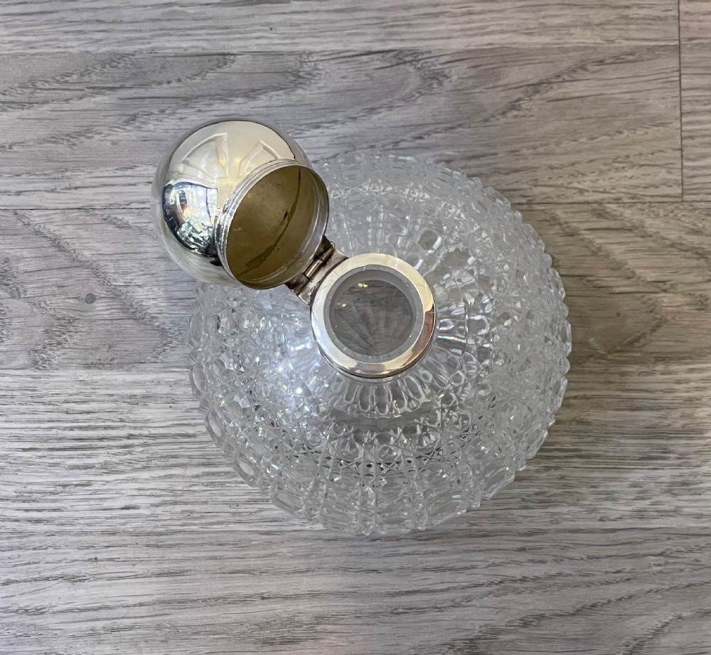 A very large Victorian solid silver topped globular cut glass scent bottle View III