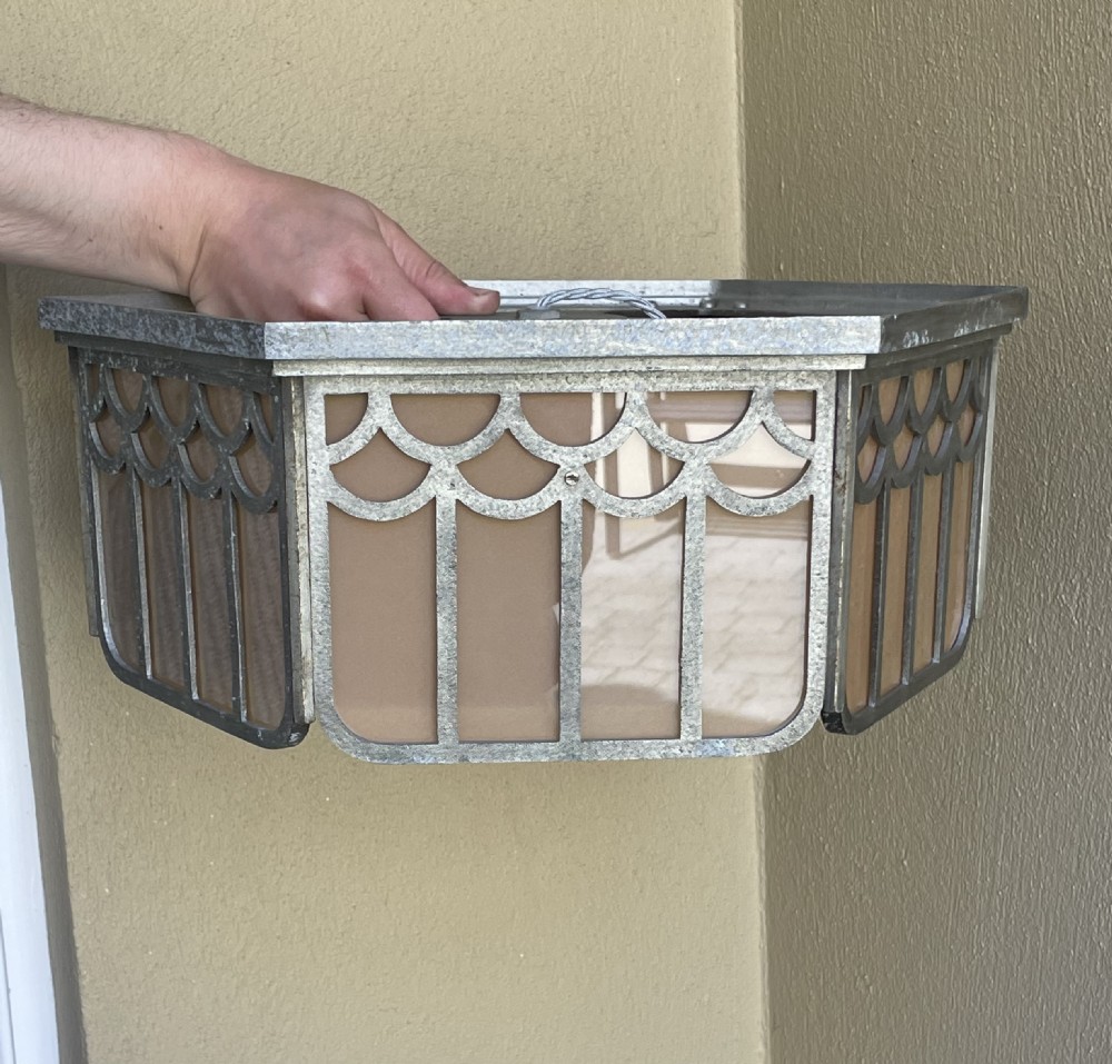 An Art Deco hexagonal flush ceiling light featuring frosted amber glass panels set within a scalloped metal frame and a central glass finial. View VIII