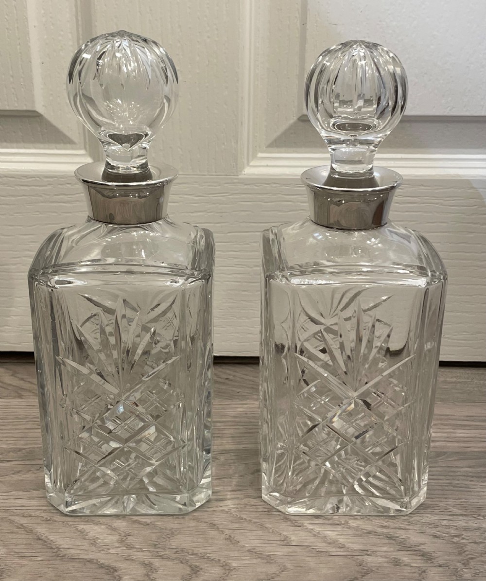 Pair of Solid Silver Topped Cut Glass Decanters