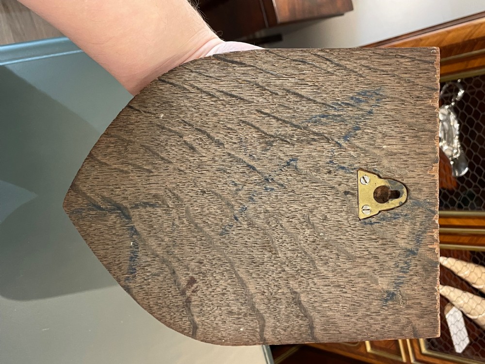 A carved oak heraldic shield featuring a gilded cockerel crest above a blue scroll banner reading VIGILATE in gold lettering. View III