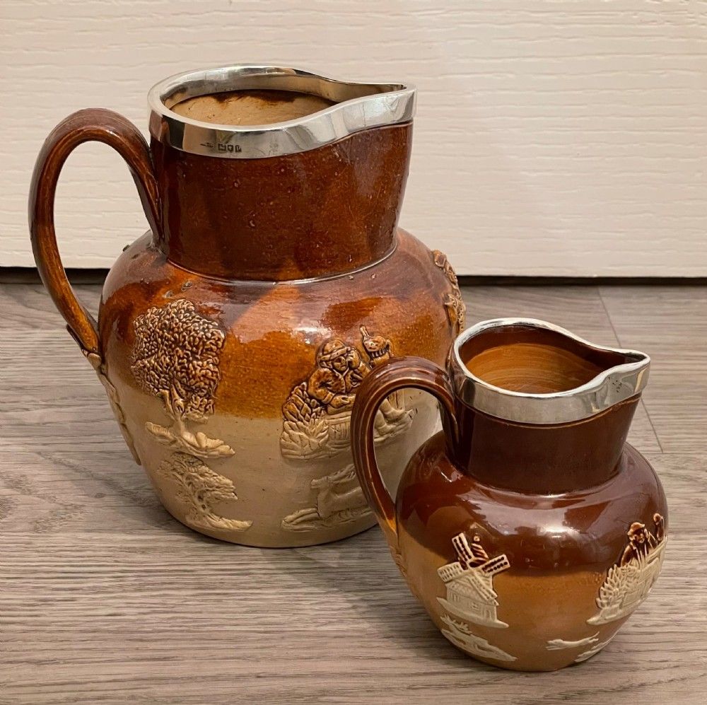 Two Victorian Doulton Lambeth Stoneware Jugs with Silver Rims
