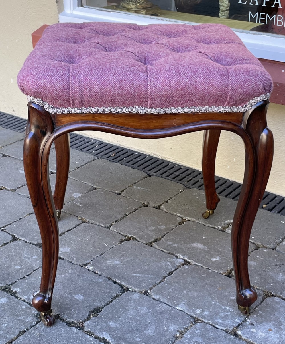 Victorian rosewood stool featuring button-tufted purple tweed upholstery, carved cabriole legs, and brass castors. View III