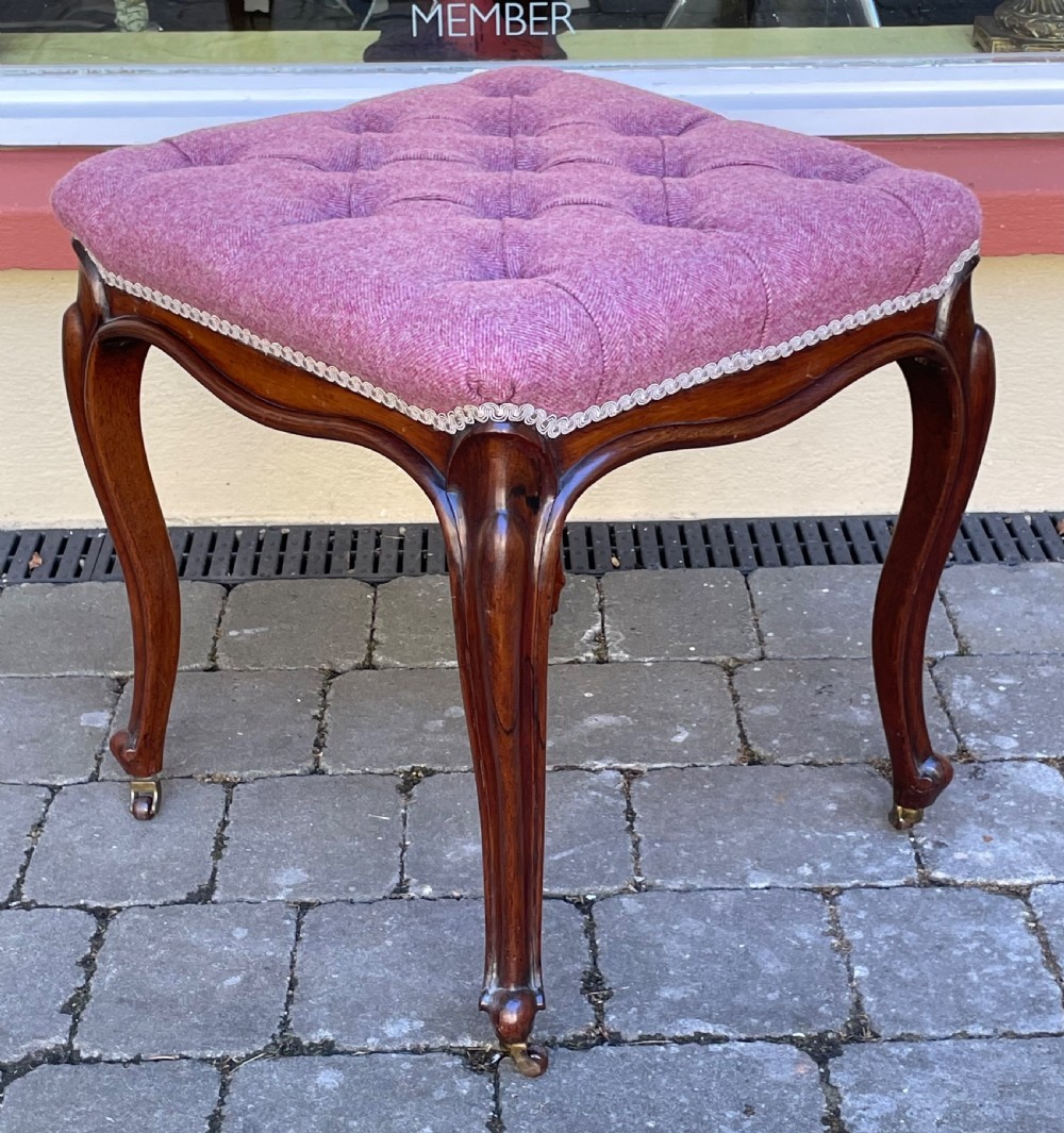 Victorian rosewood stool featuring button-tufted purple tweed upholstery, carved cabriole legs, and brass castors. View V