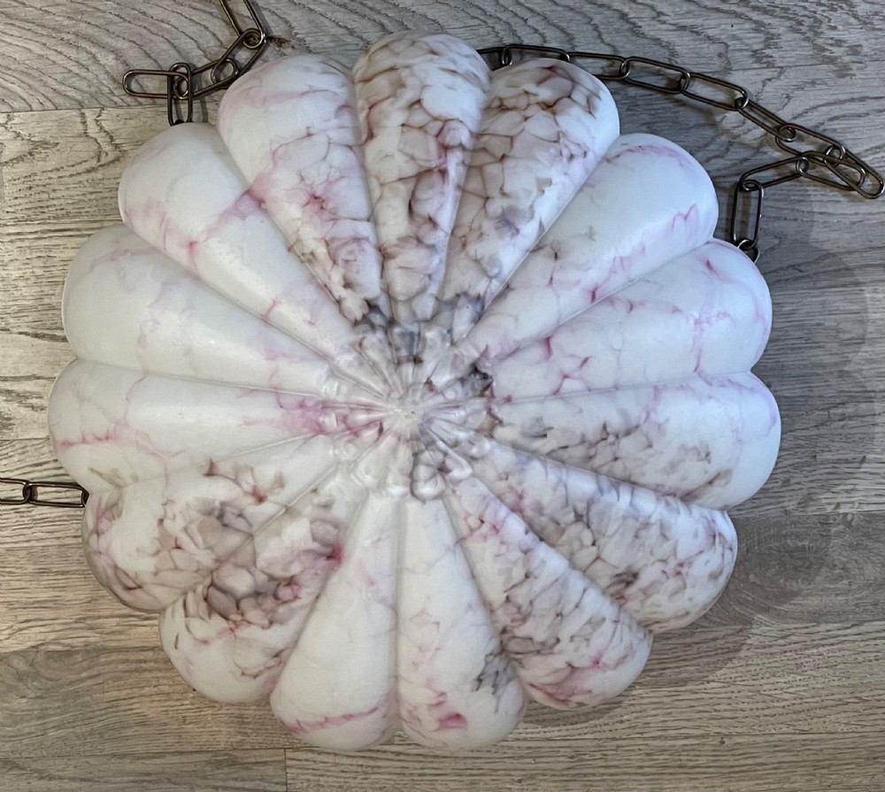 A white and pink marbled glass bowl light shade with a scalloped edge, suspended by three metal link chains. View IX