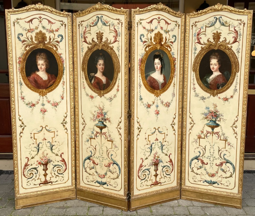 A four-panel French Rococo Revival giltwood folding screen featuring painted cream panels with central female portrait medallions and floral garlands.