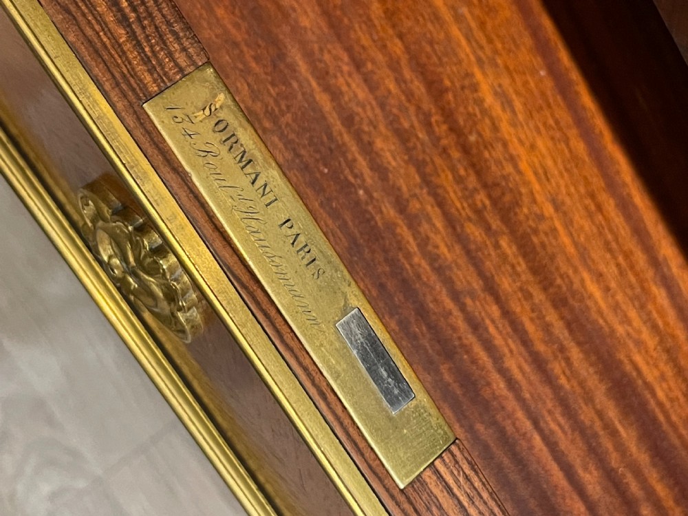French kingwood cabinet featuring wire mesh upper doors, a marble top, gilt-bronze corner mounts, a central drawer, and reeded lower doors. View V