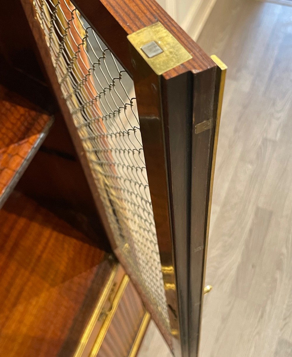 French kingwood cabinet featuring wire mesh upper doors, a marble top, gilt-bronze corner mounts, a central drawer, and reeded lower doors. View VIII
