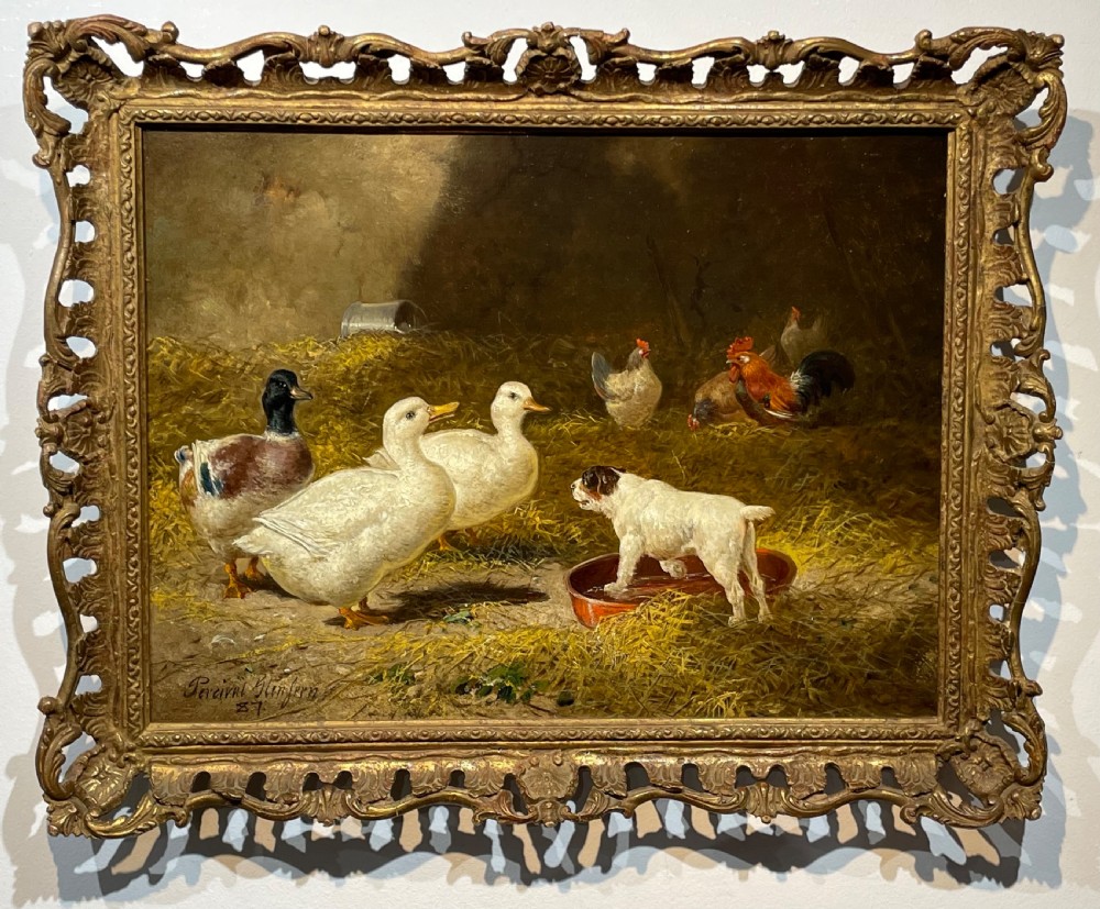 A 19th-century oil painting depicting ducks, chickens, and a small terrier inside a straw barn, enclosed in a carved gold gilt frame.