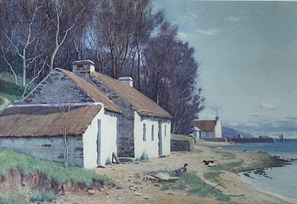 A framed watercolour painting featuring whitewashed thatched cottages on a coastal shore beside a blue sea, presented in a light-coloured mount and silver frame. View II
