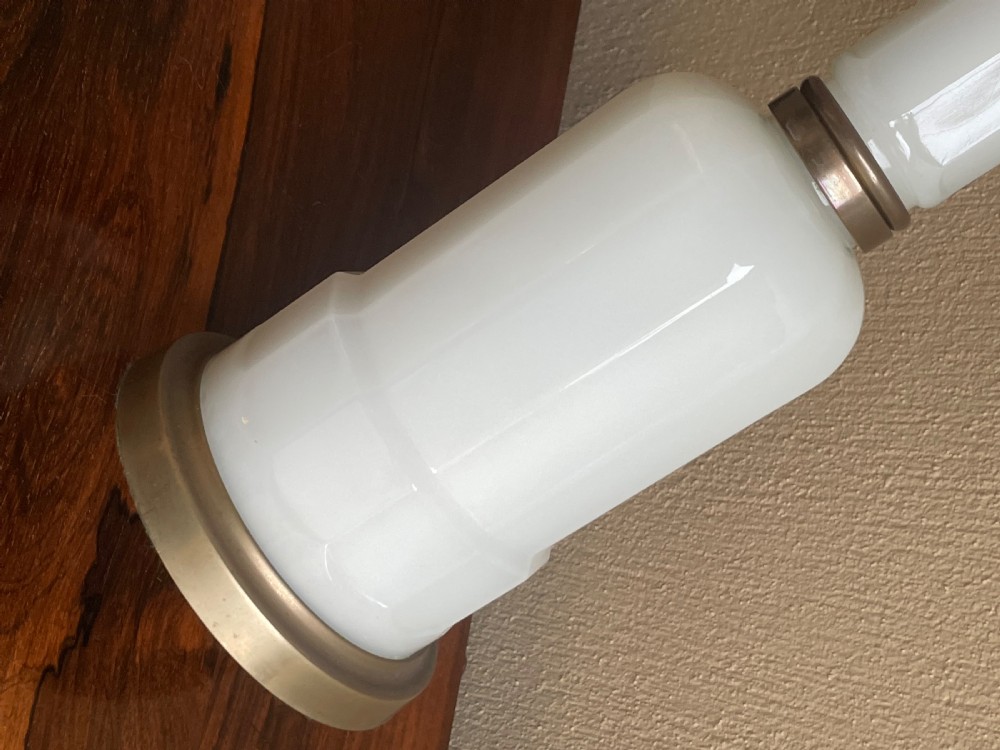 An early 20th-century table lamp base featuring a white opaline glass column set above a rounded glass lower body and circular brass base. View IV