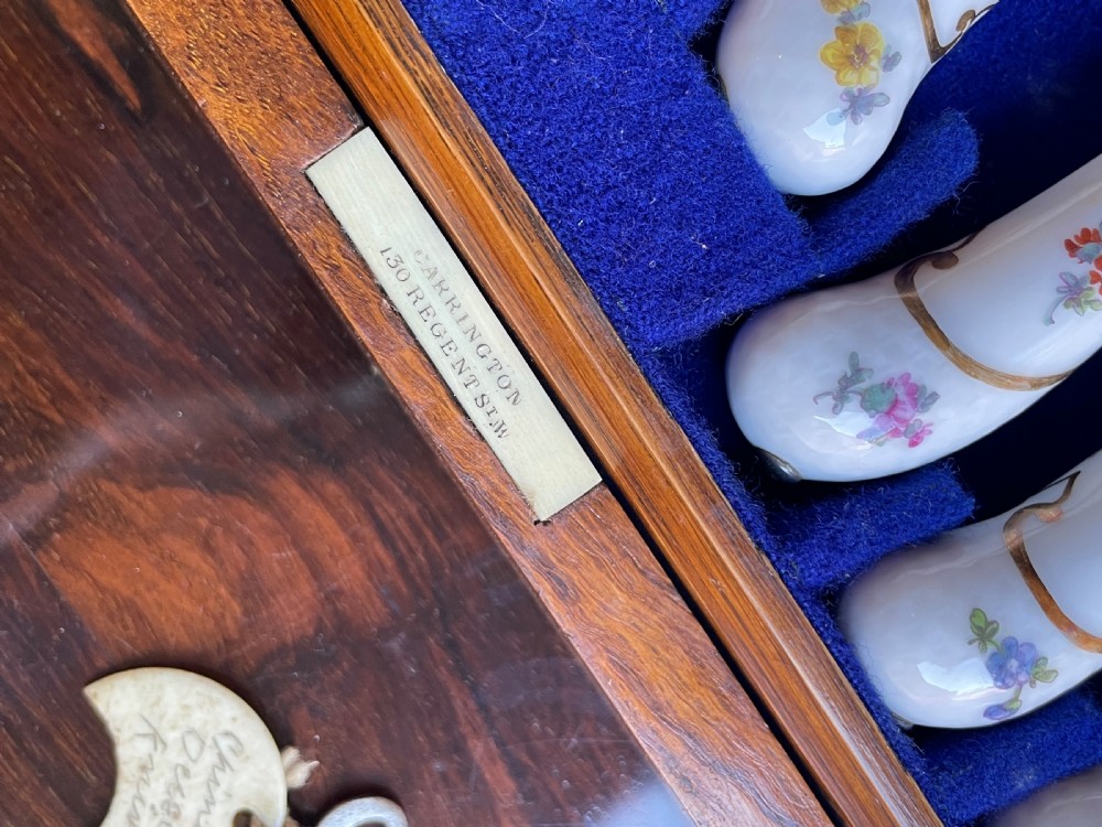 A twelve-piece silver and hand-painted porcelain dessert cutlery set housed in an open oak presentation box lined with blue velvet. View IV