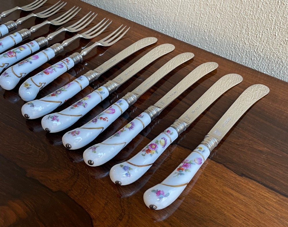 A twelve-piece silver and hand-painted porcelain dessert cutlery set housed in an open oak presentation box lined with blue velvet. View VII