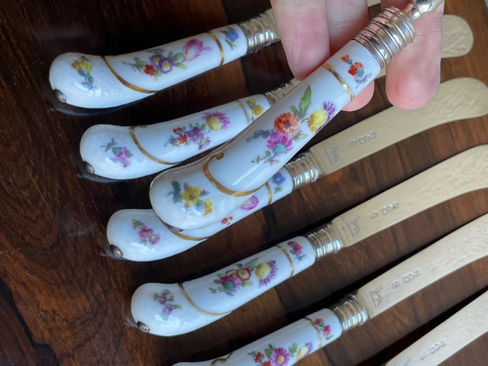 A twelve-piece silver and hand-painted porcelain dessert cutlery set housed in an open oak presentation box lined with blue velvet. View XI