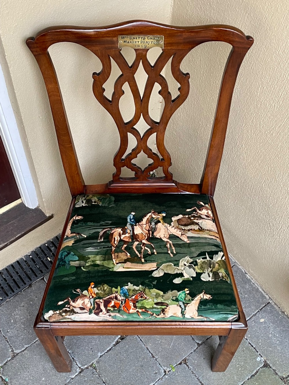 A Georgian mahogany side chair featuring a pierced back splat, an engraved brass inscription plaque on the top rail, and a printed equestrian fabric seat pad. View IV