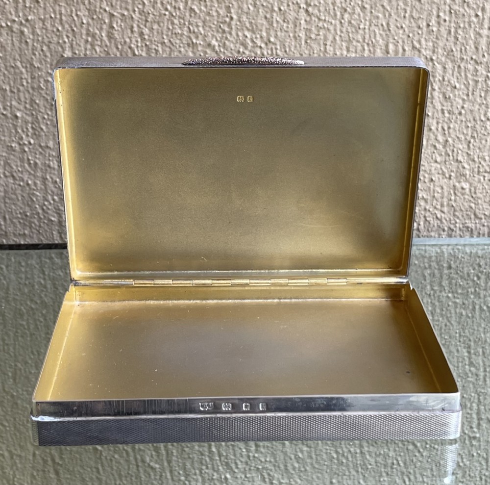 A rectangular Art Deco solid silver table box featuring fine engine-turned engraving, rounded corners, and a textured metal thumbpiece. View III