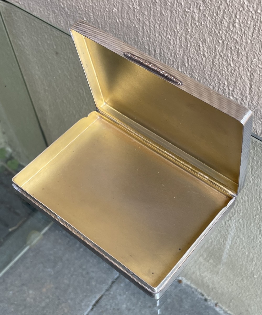 A rectangular Art Deco solid silver table box featuring fine engine-turned engraving, rounded corners, and a textured metal thumbpiece. View IV