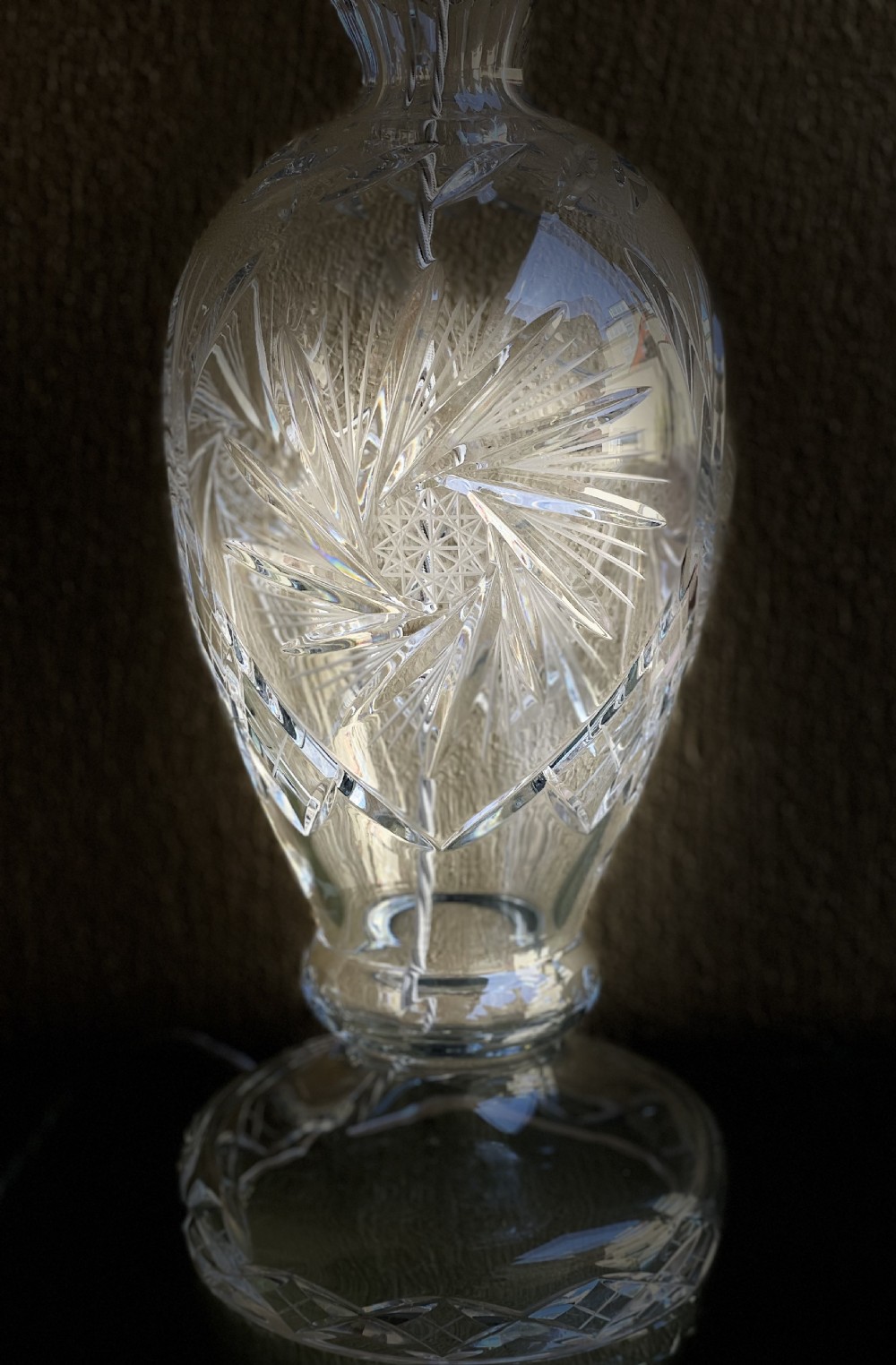 An urn-shaped clear cut crystal table lamp base with geometric starburst facets and a chrome fitting. View IV