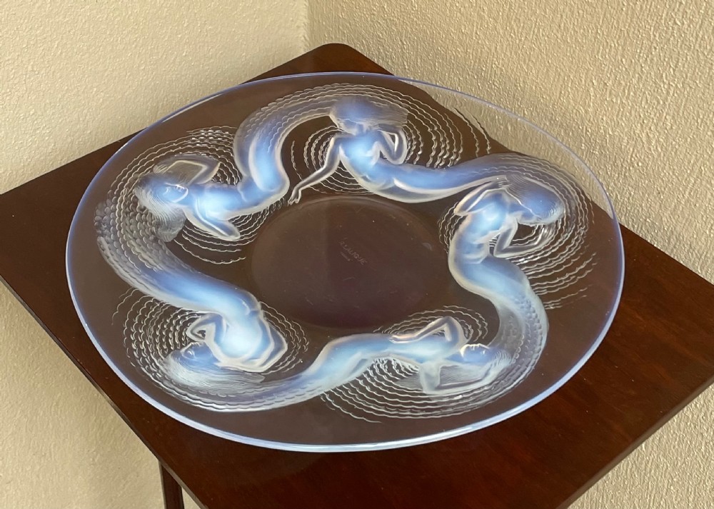 An Art Deco opalescent glass charger featuring moulded high-relief depictions of five swirling sirens around a central recessed reservoir. View II