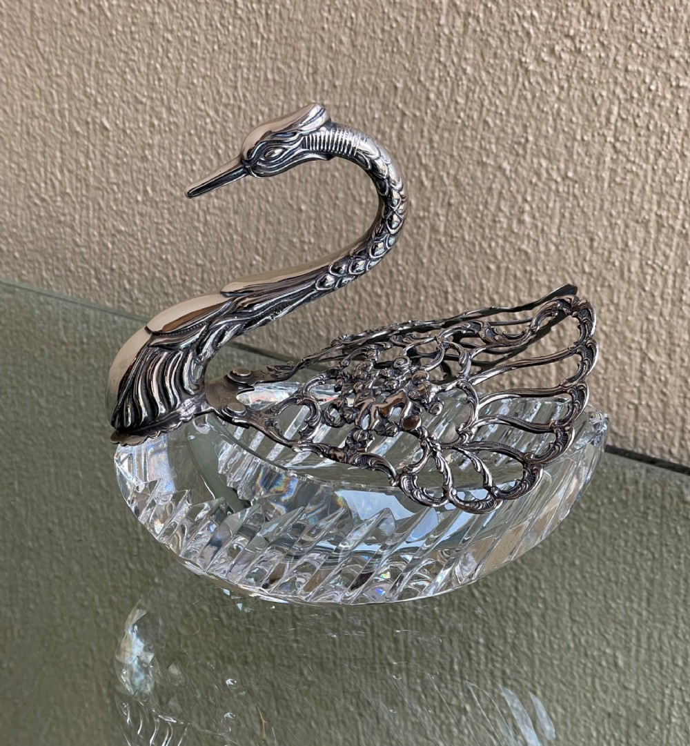 A cut glass dish featuring an ornate silver-plated swan head, neck, and articulated pierced wings. View II