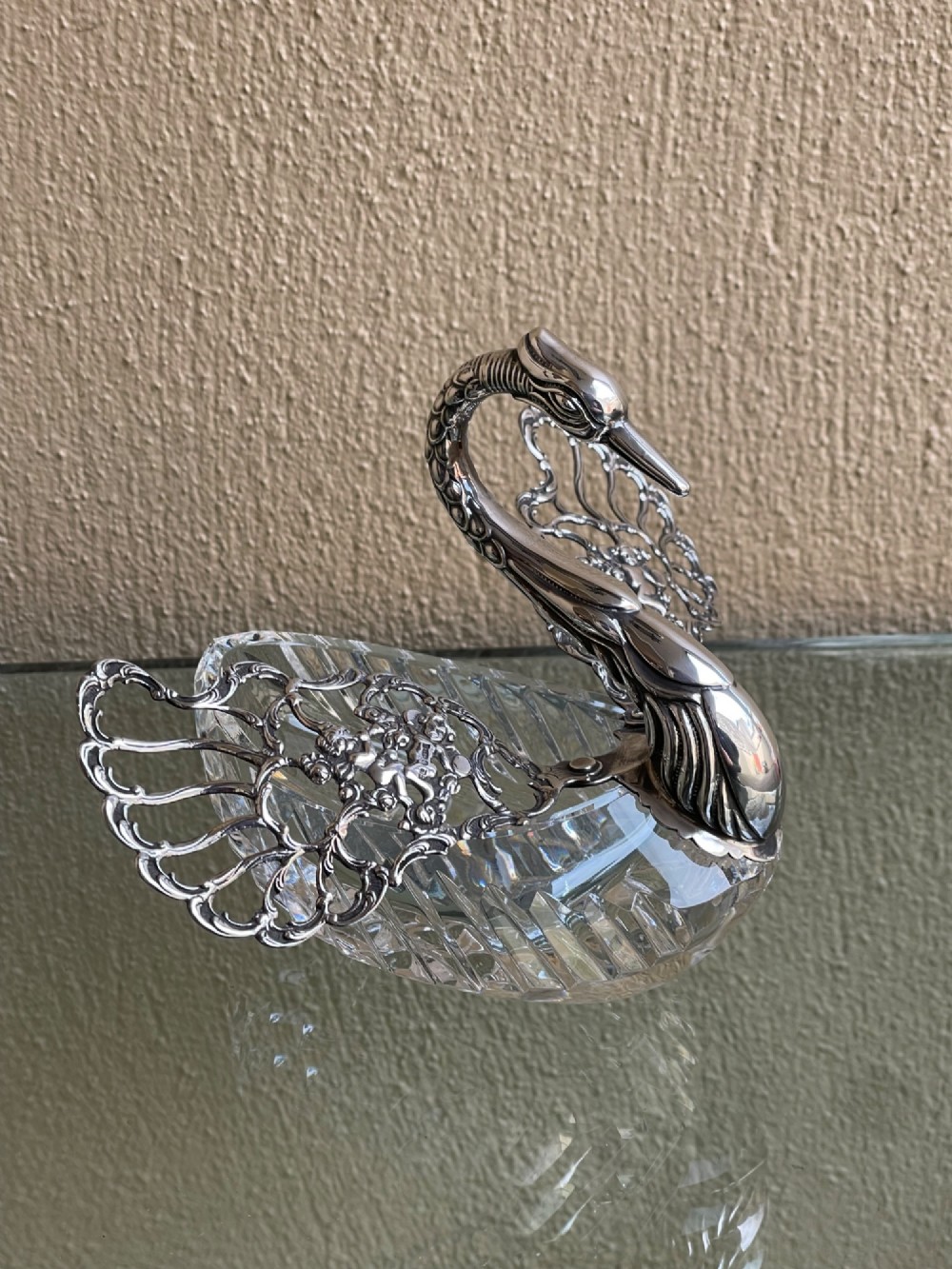 A cut glass dish featuring an ornate silver-plated swan head, neck, and articulated pierced wings. View III
