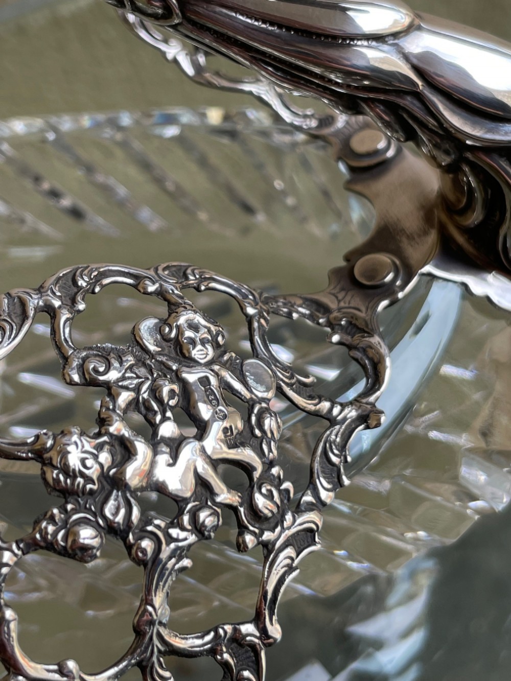 A cut glass dish featuring an ornate silver-plated swan head, neck, and articulated pierced wings. View IV