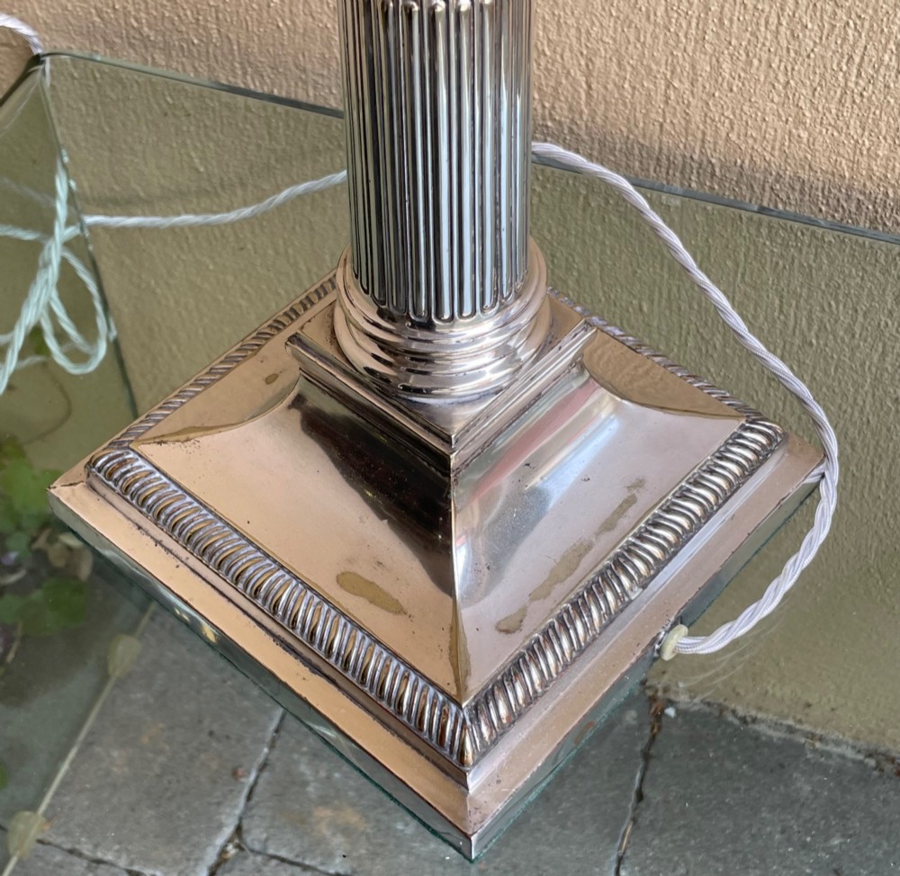 An Edwardian silver-plated table lamp shaped as a fluted Corinthian column on a stepped square base. View IV