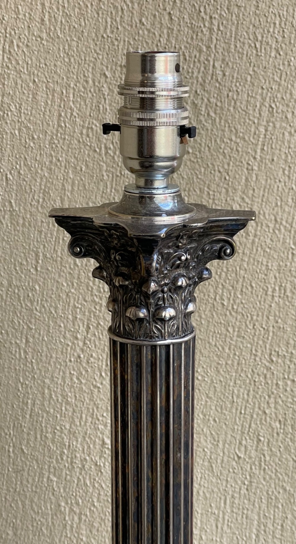 A Victorian silver-plated table lamp base styled as a fluted Corinthian column with a carved acanthus capital and a square stepped base. View IV