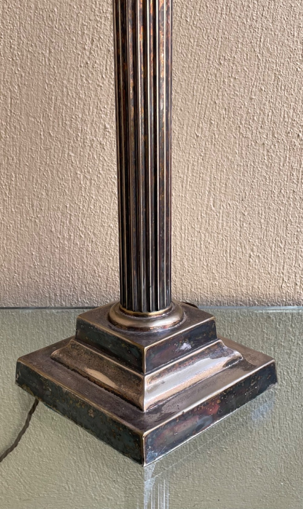 A Victorian silver-plated table lamp base styled as a fluted Corinthian column with a carved acanthus capital and a square stepped base. View V