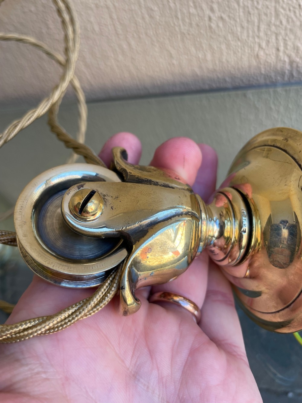 A Victorian brass rise and fall pendant light featuring a pulley mechanism, brass counterweight, twisted cord, and frosted glass shade. View III