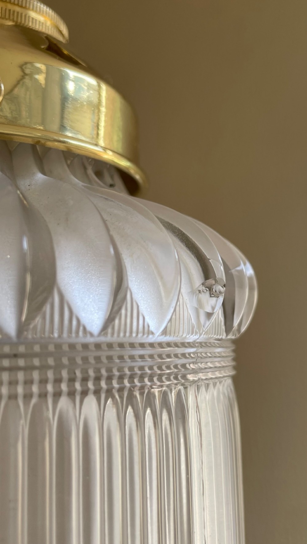 A clear ribbed Holophane glass pendant light featuring a brass gallery fitment and twisted fabric cord. View IV