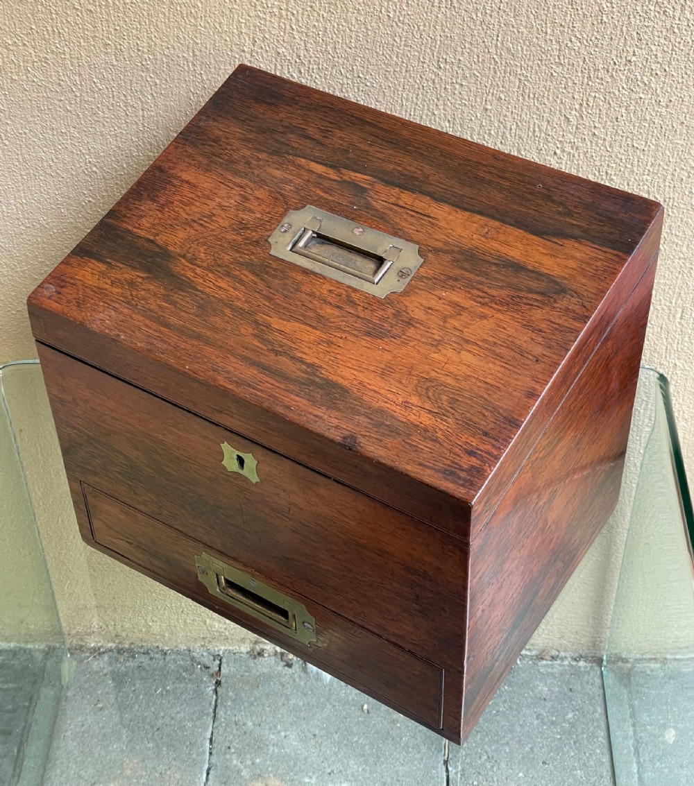 A rectangular dark wood campaign correspondence box featuring a hinged top, a brass keyhole escutcheon, and a lower drawer with a flush brass handle. View II