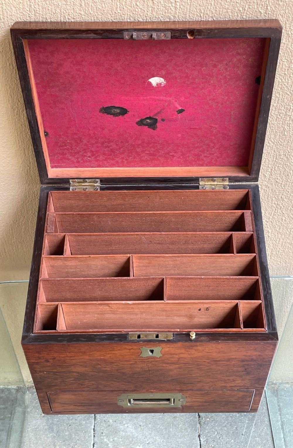 A rectangular dark wood campaign correspondence box featuring a hinged top, a brass keyhole escutcheon, and a lower drawer with a flush brass handle. View IV