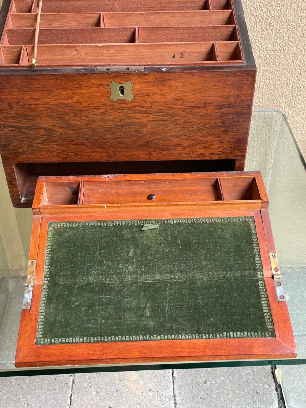 A rectangular dark wood campaign correspondence box featuring a hinged top, a brass keyhole escutcheon, and a lower drawer with a flush brass handle. View VI