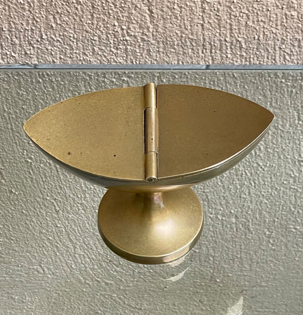 A Georgian navette-shaped brass table snuff box with a central hinged lid elevated on a circular pedestal foot. View II